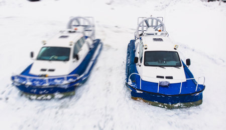 View of rescue team Hovercraft. hover craft transport boat crossing frozen river lake on the ice in the winter snowy dayの写真素材