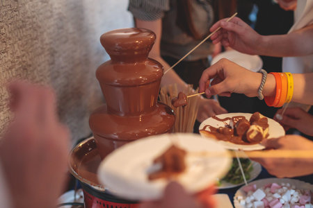 Vibrant Picture of Chocolate Fountain Fontaine on a children kids birthday party with a kids playing...
