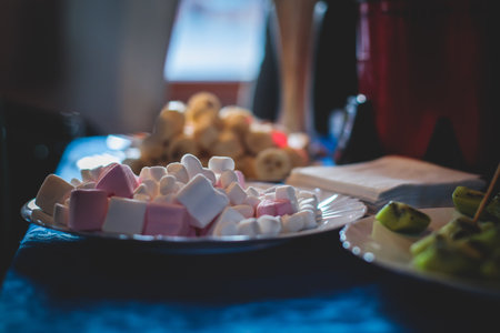 Vibrant Picture of Chocolate Fountain Fontaine on a children kids birthday party with a kids playing around and dipping marshmallows and fruits into the fountainの写真素材