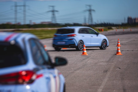 View of autodrome race circuit racetrack with a line of cars driving and racing, with audience and during rally autocross racing competitionの写真素材