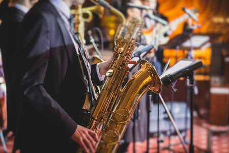 Concert view of a saxophonist, saxophone player with vocalist and musical during jazz orchestra performing music on stageの写真素材