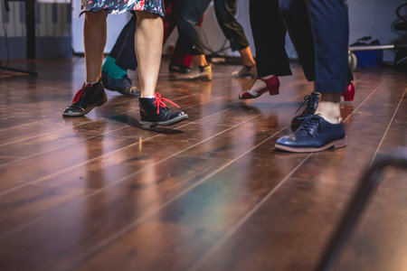 Dancing shoes of young couple dance retro jazz swing dances on a ballroom club wooden floor, close up view of shoes, female and male, dance lessonsの写真素材
