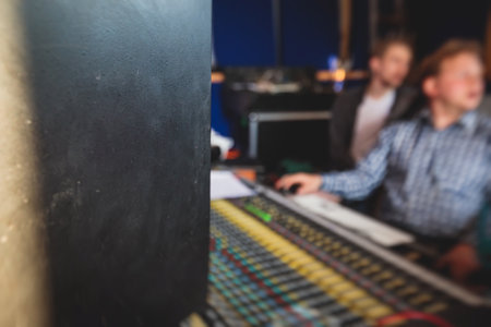 Sound editor engineer working at studio with mixing mixing panel, music and sound, stage sound mixer, boutique recording studio, working during concert performance recording, broadcasting studioの写真素材