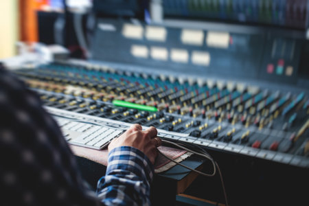 Sound editor engineer working at studio with mixing mixing panel, music and sound, stage sound mixer, boutique recording studio, working during concert performance recording, broadcasting studioの写真素材
