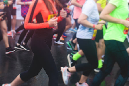 Marathon runners crowd, participants start running the half-marathon in the city streets, crowd of joggers in motion, group athletes outdoor training competitionの写真素材