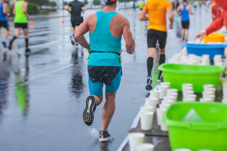Marathon runners crowd, participants start running the half-marathon in the city streets, crowd of joggers in motion, group athletes outdoor training competitionの写真素材