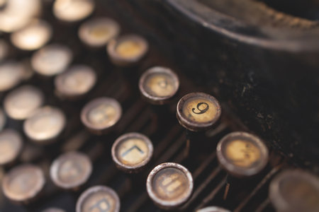 Vintage typewriter with Cyrillic alphabet characters keyboard, writing text letter on empty page...