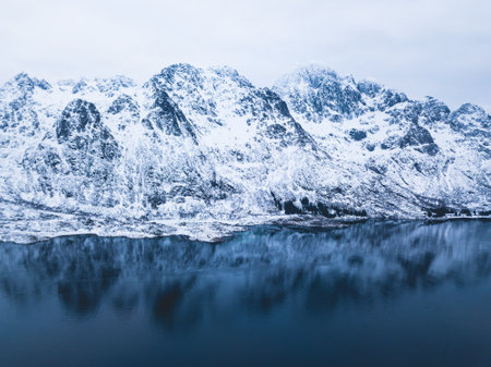 Aerial winter view of Lofoten Islands, Nordland, Norway, with fjord, road and mountains, shot from droneの写真素材