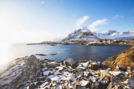 Beautiful super wide-angle winter snowy view of fishing village A, Norway, Lofoten Islands, with skyline, mountains, famous fishing village with red fishing cabins, Moskenesoya, Nordlandの写真素材