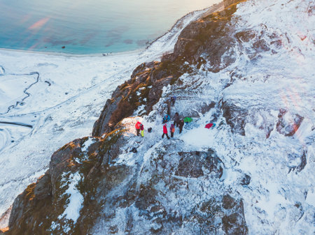 Norwegian winter sunny mountain landscape blue sky view with mountains, fjord, Norway, Ryten peak - famous mountain in Lofoten Islands, Moskenes municipality, Nordland, shot from droneの写真素材