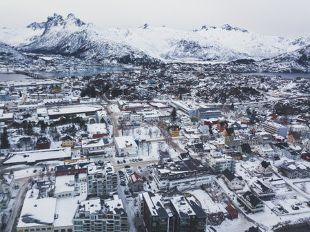 Beautiful super wide-angle winter snowy view of Svolvaer, Norway, Lofoten Islands, with skyline, mountains, Austvagoya island, Vagan municipality, Nordland, Northern Norwayの写真素材