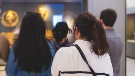 Group of students on excursion tour visit gallery museum with tour guide, a docent with a tourist adult visitors on archeology exhibition with contemporary art, hall with paintings and exhibitsの写真素材