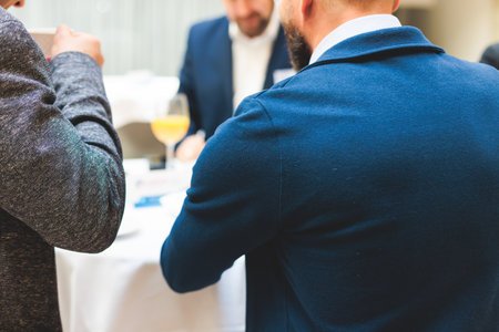 Group of men in business suits talking and discussing during coffee break at conference, politicians and entrepreneurs networking and negotiate, businessmen have dialog conversation on a forumの写真素材