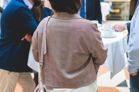 Group of women in business suits talking and discussing during coffee break at conference, female politicians and entrepreneurs networking and negotiate, businesswomen dialog conversation on a forumの写真素材