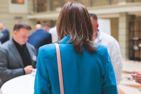 Group of women in business suits talking and discussing during coffee break at conference, female politicians and entrepreneurs networking and negotiate, businesswomen dialog conversation on a forumの写真素材