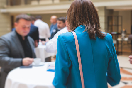 Group of women in business suits talking and discussing during coffee break at conference, female politicians and entrepreneurs networking and negotiate, businesswomen dialog conversation on a forumの写真素材