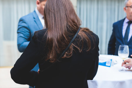 Group of women in business suits talking and discussing during coffee break at conference, female politicians and entrepreneurs networking and negotiate, businesswomen dialog conversation on a forumの写真素材