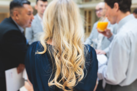 Group of women in business suits talking and discussing during coffee break at conference, female politicians and entrepreneurs networking and negotiate, businesswomen dialog conversation on a forumの写真素材