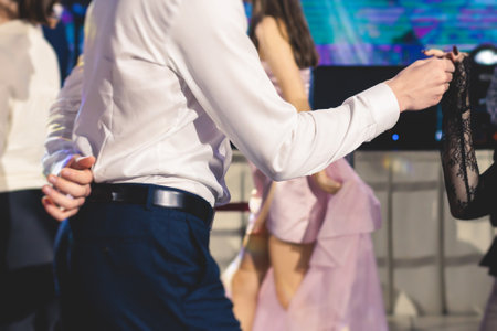 High school graduates dancing Waltz and classical ball dance in dresses and suits on a school prom graduation, classical ballroom dancers dancing, Waltz, couples quadrille and polonaiseの写真素材
