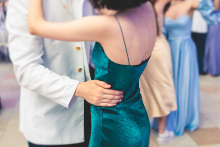 High school graduates dancing Waltz and classical ball dance in dresses and suits on a school prom graduation, classical ballroom dancers dancing, Waltz, couples quadrille and polonaiseの写真素材