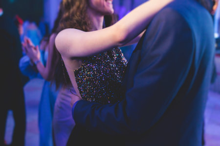 High school graduates dancing Waltz and classical ball dance in dresses and suits on a school prom graduation, classical ballroom dancers dancing, Waltz, couples quadrille and polonaiseの写真素材