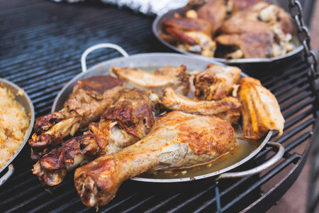 Food festival with food stall kiosk, open-air outdoor fair market, assortment of different traditional European grilled barbecued street food with sausages, bbq, chicken, pork and lamb on a large panの写真素材
