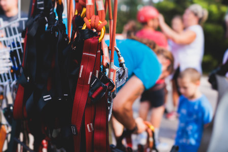 Equipment for climbing sport outdoor, rock climbing alpinism mountaineering gear with helmet, belt, carabiner, rope, harness with belay and protection for the high ropes courseの写真素材