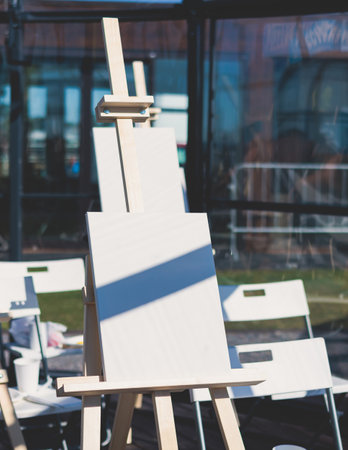 Process of drawing, group class of talented students with painting easels and canvases during lesson of watercolor painting outdoors, drawing class for adult artists in art schoolの写真素材
