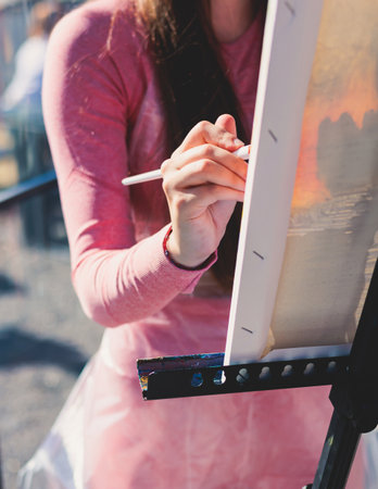 Process of drawing, group class of talented students with painting easels and canvases during lesson of watercolor painting outdoors, drawing class for adult artists in art schoolの写真素材