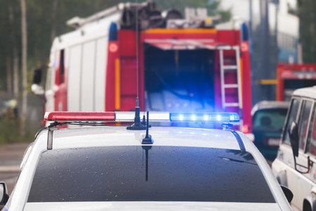 Fire fighting equipment in the city, with red fire engine truck during fire fighting operation in...