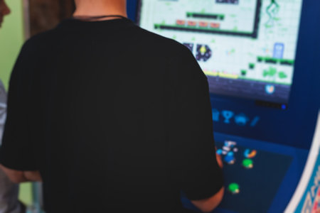 Kids play slot machine at amusement theme park, children play arcade gaming machine, racing and shooting game at the fair, teenagers having fun playing simulator video gamesの写真素材