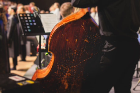 Concert view of violoncello player with vocalist and musical orchestra band, during jazz concert, performing music, violoncellist cello jazz player on stage, old retro vintage contrabassの写真素材