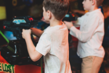 Kids play slot machine at amusement theme park, children play arcade gaming machine, racing and shooting game at the fair, teenagers having fun playing simulator video gamesの写真素材