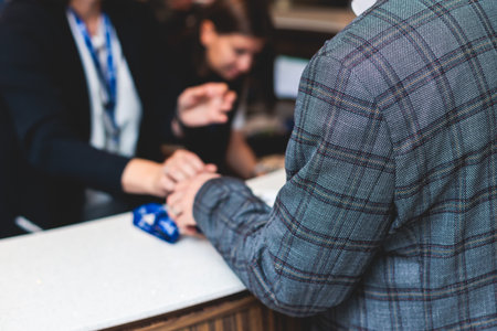 Process of checking in on a conference congress forum event, registration desk table, visitors and...