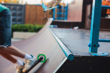 Skate park with kids on a kick scooter doing tricks and stunts, boys in a skate park riding bmx bike...