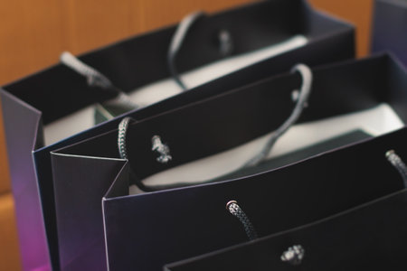 Corporate gifts and souvenirs for company employees, gift bag package for conference participants before start, presentation of corporate gifts, gift giving at office work, dark blue paper bag bunchの写真素材