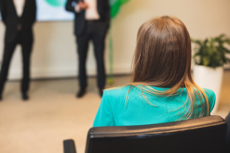 Female participants audience at the symposium meeting, attendees in conference room hall listens to lecturer, group of women on a congress together listen to speaker on a stage at master-classの写真素材