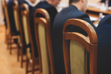 Group of men in business suits talking and discussing at conference, politicians and entrepreneurs debate, networking and negotiate, businessmen have dialog conversation on a forum, panel discussionの写真素材