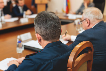 Group of men in business suits talking and discussing at conference, politicians and entrepreneurs debate, networking and negotiate, businessmen have dialog conversation on a forum, panel discussionの写真素材