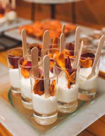 Catering table, beautifully decorated banquet with variety of with different food snacks appetizers on corporate birthday party event or wedding celebration, canape, salad, delicatessen settingの写真素材