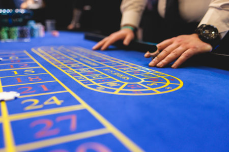 Vibrant casino table with roulette in motion, with casino chips, tokens, the hand of croupier,...