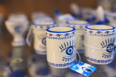Traditional tourist souvenirs and gifts from Greece, refrigerator magnets with text "Greece", and key ring keychain, mugs and toys in a local vendor shop in Athens, Attica, Greece, greek souvenirsの写真素材