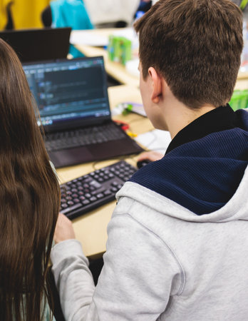Software developer students in auditorium hall working on computer and laptop, programming contest hackathon competition, pc with coding program app, competitive programming for software engineerの写真素材