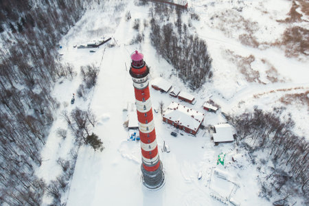 Snowy aerial drone view of Storozhenskiy Light, Ladoga Lake, Storozhno Lighthouse, Storozhno village, Leningrad oblast region, Russia, winter sunny day, lighthouses of Russia travelの写真素材