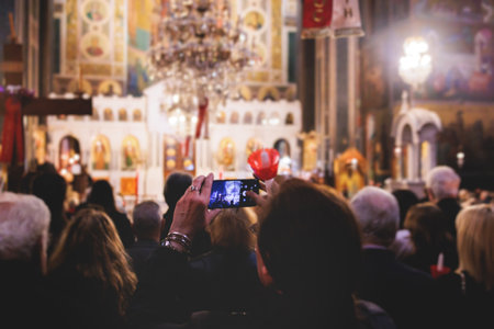Greek Orthodox Christian Easter ceremony procession, divine worship service, worshipers hold...