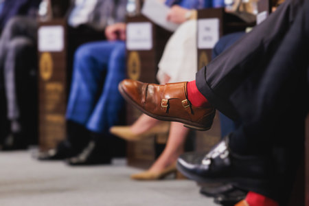 Speakers shoes legs at the business conference event, audience on forum summit, plenary session lecture hall, persons on a stage at plenary meeting, business congress at the venue, panel discussionの写真素材