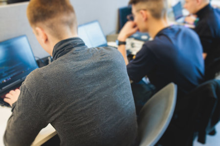 Software developer students in auditorium hall working on computer and laptop, programming contest hackathon competition, pc with coding program app, competitive programming for software engineerの写真素材