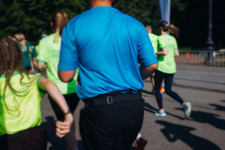 Marathon runners crowd, sportsmen participants start running the half-marathon in the city streets,...
