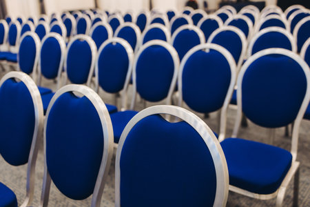 Empty modern conference hall, venue for congress lecture, line row of chairs, auditorium for convention and press conference event, interior of room for presentation with a lot of seats and no peopleの写真素材