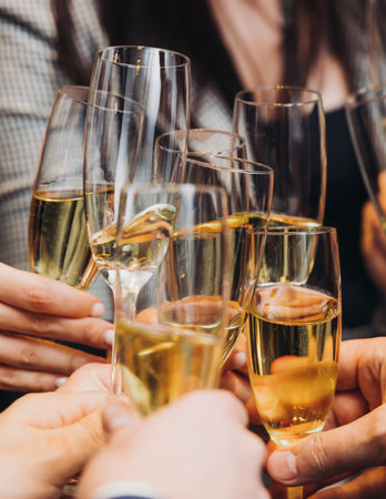 Group of businessmen celebrate, closing successful completed deal, guests clinking raise glasses with alcohol, sparkling wine, toasting and cheering, colleagues team in office on corporate party eventの写真素材